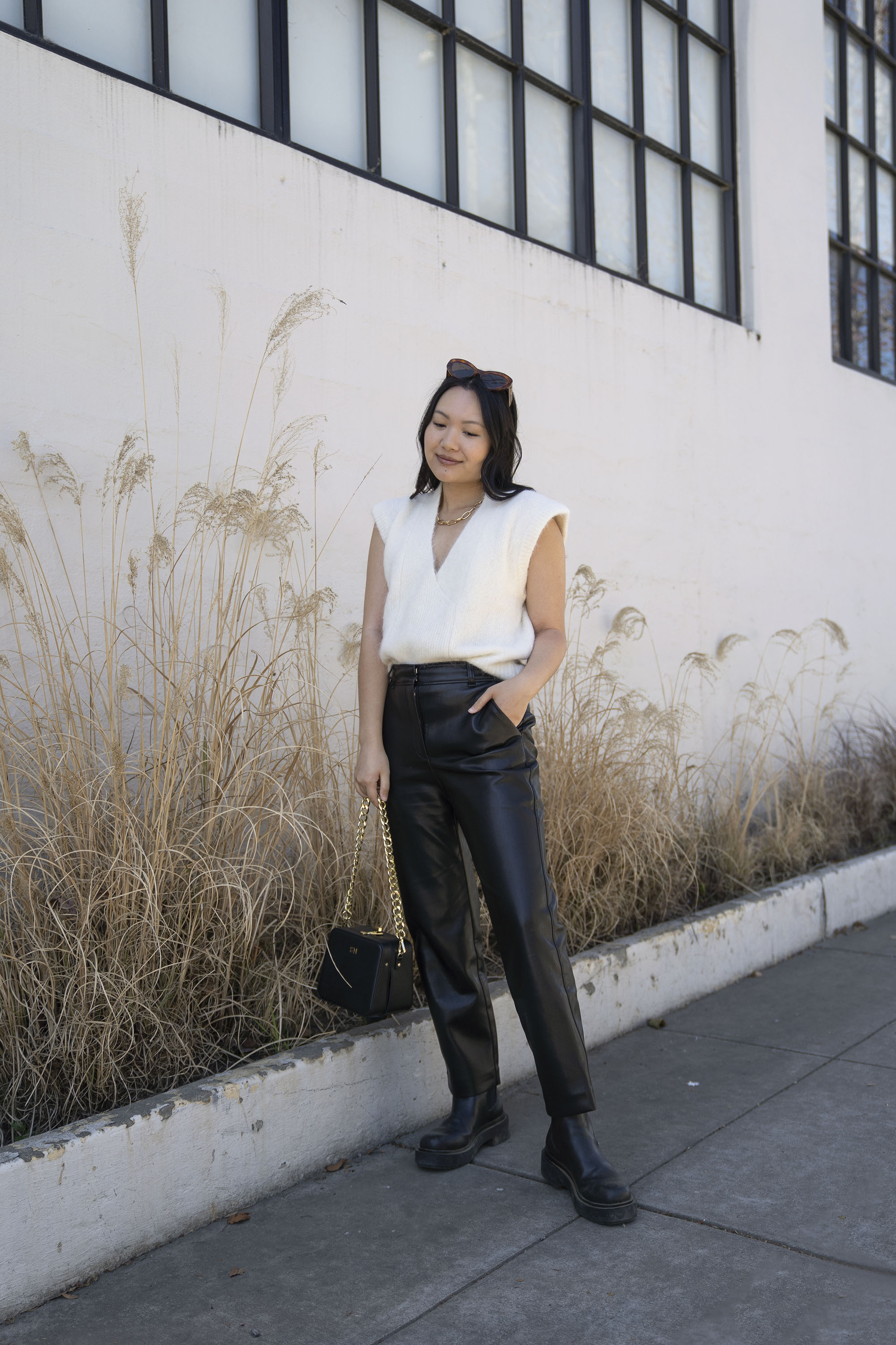 sweater vest and leather trousers